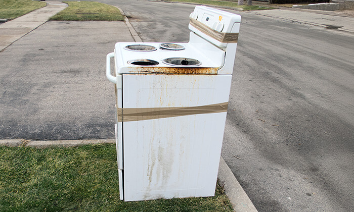 What to do with old stove 1-800-GOT-JUNK? hauls away an old stove with an appliance dolly.