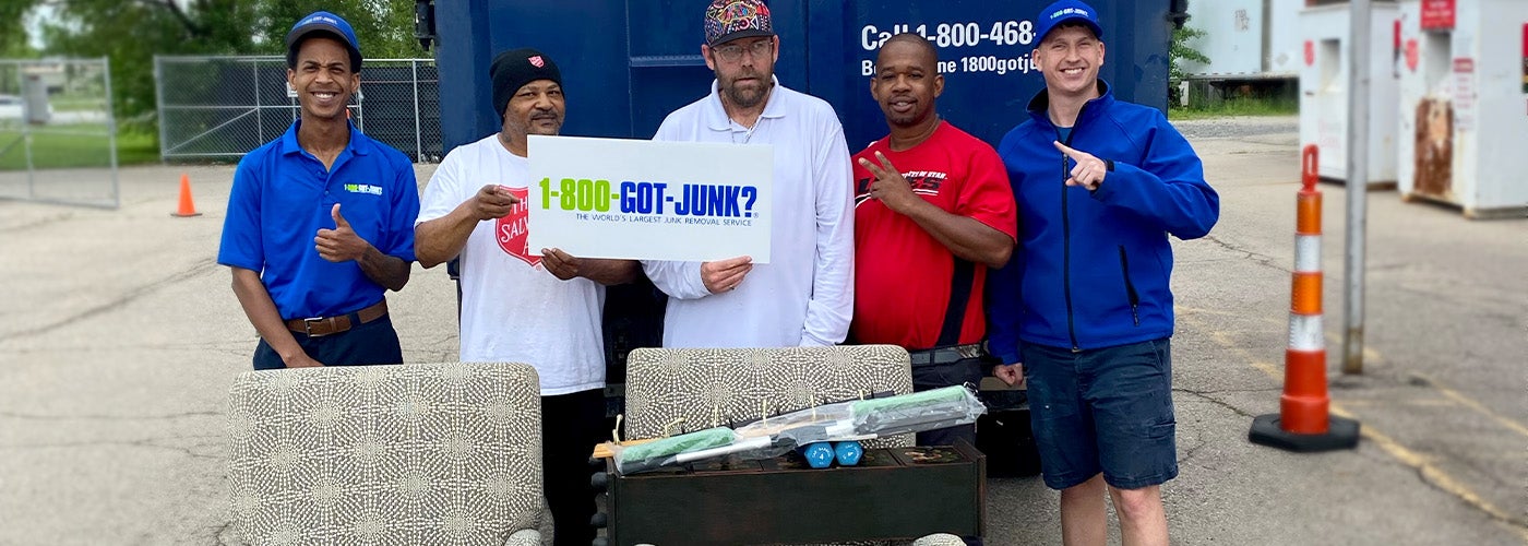 1-800-GOT-JUNK? Cincinnati truck and team donating furniture - posing for photo with the Salvation Army team