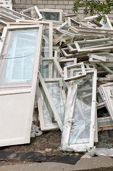 Large pile of glass windows for scrap glass recycling