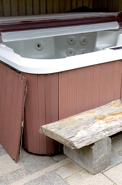 An old jacuzzi that's ready for hot tub removal and disposal