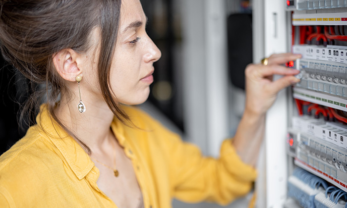 A woman disconnecting plumbing and electrical.