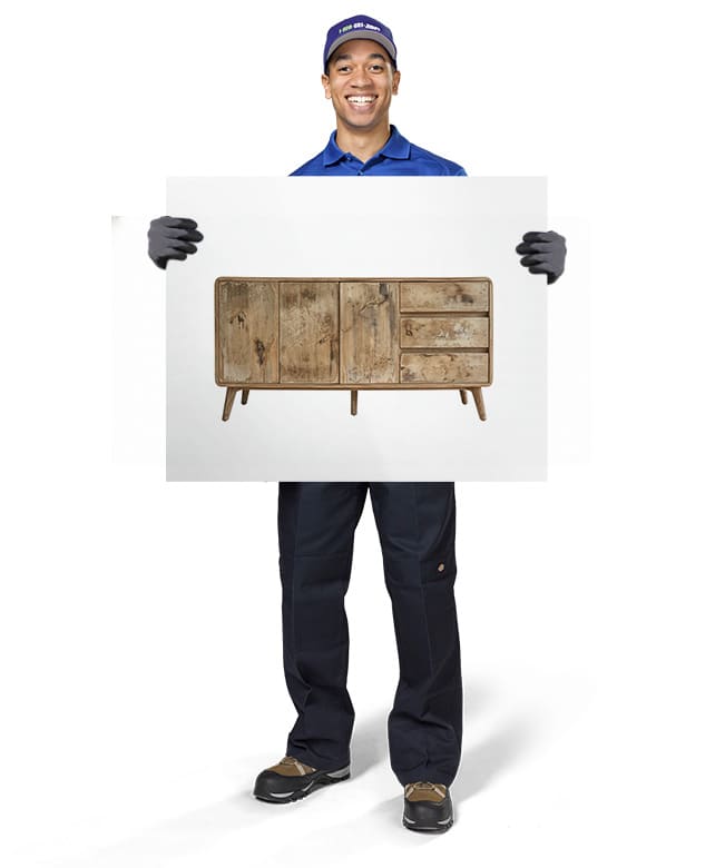 1-800-GOT-JUNK? Truck Team Member holding an image of a TV stand