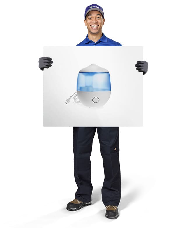 1-800-GOT-JUNK? Truck Team Member holding an image of a humidifier