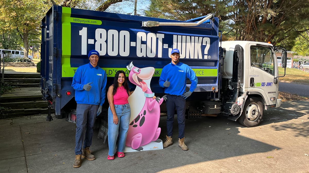 Dina Younis and 1-800-GOT-JUNK? Dina Younis with two 1-800-GOT-JUNK? Truck Team Members and a life size Dino cut-out