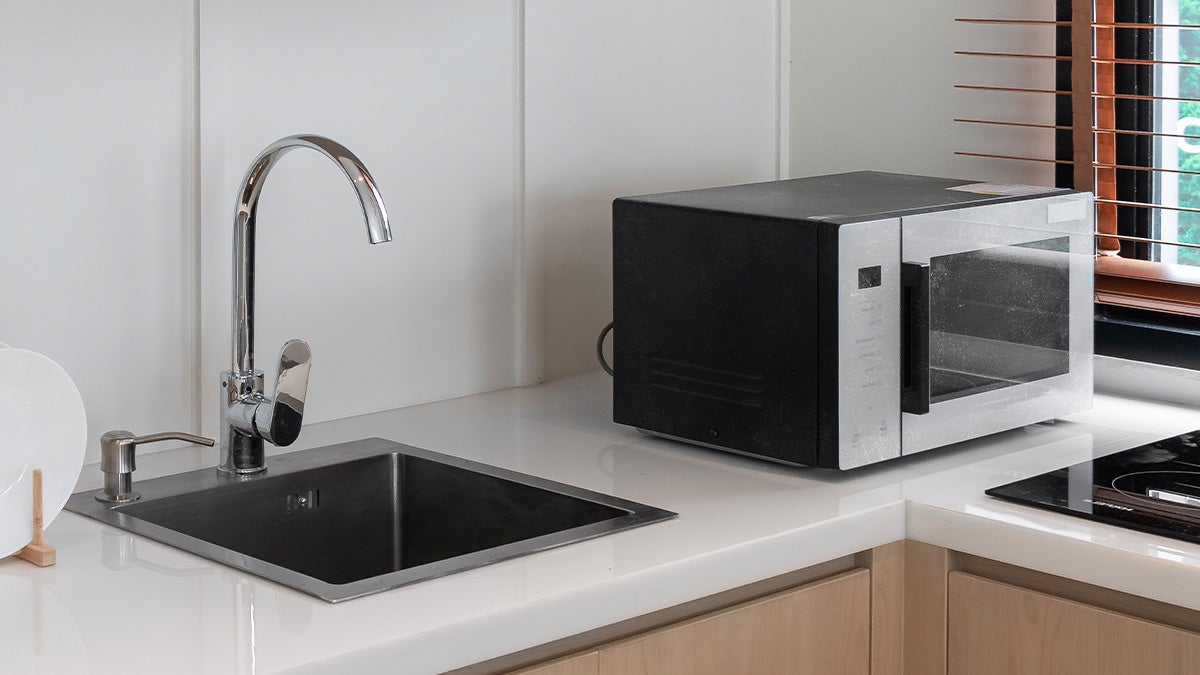 Old microwave on kitchen counter