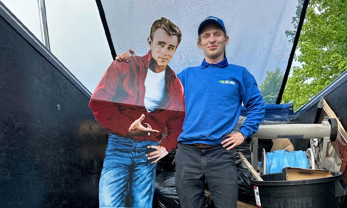 A 1-800-GOT-JUNK? Truck Team Member with a James Dean cutout