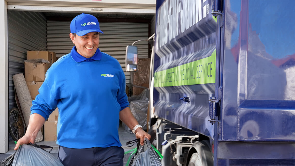 1-800-GOT-JUNK? team helping a family clean out a storage unit.