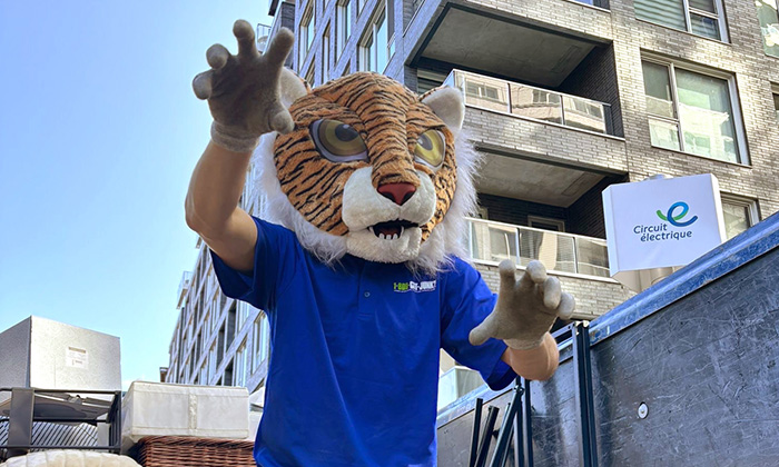 A 1-800-GOT-JUNK? Truck Team Member in a tiger mask.